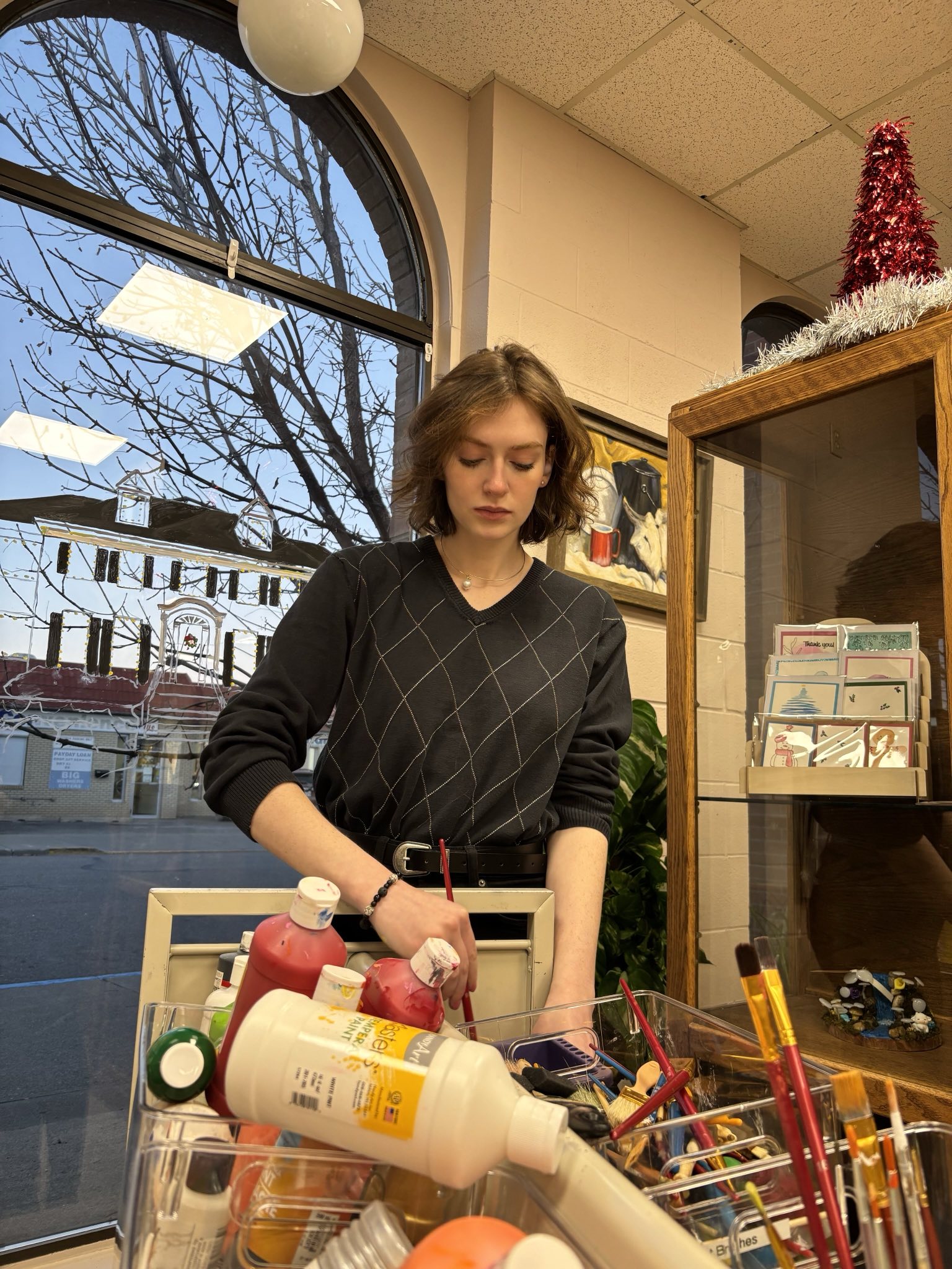 Amanda Ruby painting at an art supply shop